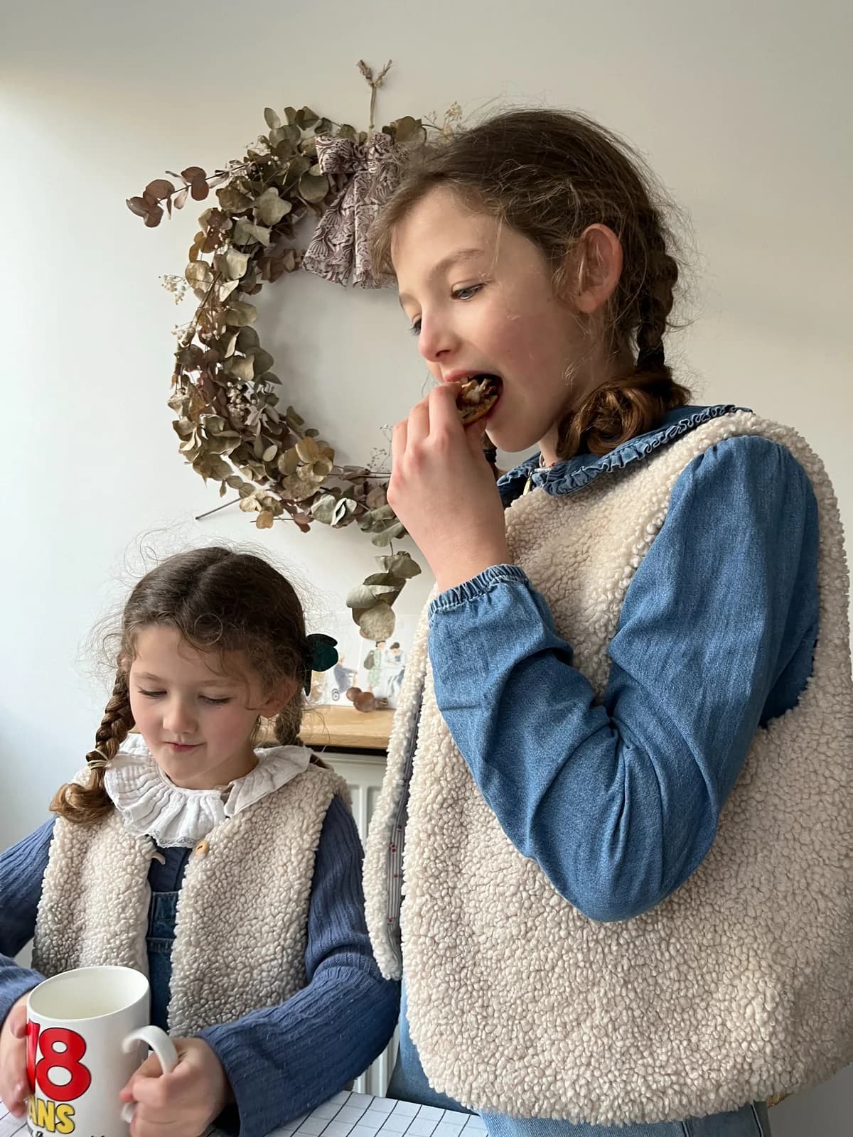 Sœurs au petit-déjeuner Deux sœurs en gilets berger et blouses en jean au petit-déjeuner — By Mésange